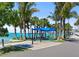 Relaxing beachside lounge area featuring shady spots and seating amidst tropical palm trees at 750 N Tamiami Trl # 604, Sarasota, FL 34236