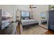 Bright bedroom features a ceiling fan, a mirror, a window overlooking a beautiful view and a comfortable bed at 750 N Tamiami Trl # 604, Sarasota, FL 34236