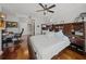 Bedroom with hardwood floors, a ceiling fan, ample storage, and an attached bathroom at 750 N Tamiami Trl # 604, Sarasota, FL 34236