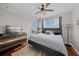 Bedroom featuring hardwood floors, a ceiling fan, and a dresser with a television at 750 N Tamiami Trl # 604, Sarasota, FL 34236