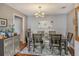 Dining room features a wooden table with seating for six, modern chandelier, and neutral decor at 750 N Tamiami Trl # 604, Sarasota, FL 34236