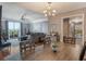 Open-concept dining area, showcasing a modern chandelier, seating and access to the living area at 750 N Tamiami Trl # 604, Sarasota, FL 34236