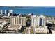 View of upscale waterfront condo buildings with beautiful views of bay and modern architectural design and lush landscaping at 750 N Tamiami Trl # 604, Sarasota, FL 34236