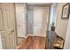 View of entryway with hardwood floors, entry closet, and a glimpse into the bright living area at 750 N Tamiami Trl # 604, Sarasota, FL 34236