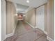Long hallway with patterned carpet and painted walls leads to other areas of the home at 750 N Tamiami Trl # 604, Sarasota, FL 34236