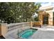 Inviting community hot tub, surrounded by lush landscaping, and balustrade fence at 750 N Tamiami Trl # 604, Sarasota, FL 34236