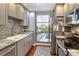 Well-equipped kitchen with stainless steel appliances, ample counter space, and a large window with a view at 750 N Tamiami Trl # 604, Sarasota, FL 34236
