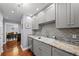 Kitchen featuring gray cabinets, granite countertops, stainless steel appliances, and hardwood floors at 750 N Tamiami Trl # 604, Sarasota, FL 34236