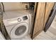 Laundry room featuring side by side Samsung washer and dryer appliances next to a rustic barn door at 750 N Tamiami Trl # 604, Sarasota, FL 34236
