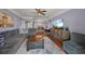 Inviting living room with hardwood floors, ceiling fan, and a dining area in the background at 750 N Tamiami Trl # 604, Sarasota, FL 34236