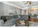 Living room with a sectional sofa, wooden coffee table, and stylish decor at 750 N Tamiami Trl # 604, Sarasota, FL 34236