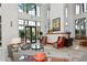 Bright lobby with high ceilings, gray couches, orange chairs, and walls of windows letting in natural light at 750 N Tamiami Trl # 604, Sarasota, FL 34236