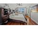 Main bedroom with hardwood floors, a ceiling fan, and a large window with city views at 750 N Tamiami Trl # 604, Sarasota, FL 34236