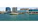 Picturesque marina view showcasing boats docked near a waterfront building with turquoise water at 750 N Tamiami Trl # 604, Sarasota, FL 34236