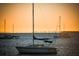 Beautiful sailboats floating on calm ocean at sunset, distant city skyline in the background at 750 N Tamiami Trl # 604, Sarasota, FL 34236