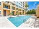 A refreshing swimming pool for residents, surrounded by elegant architecture and inviting outdoor seating at 750 N Tamiami Trl # 604, Sarasota, FL 34236