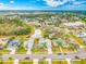 Aerial view of the property in a beautiful neighborhood with mature trees, ponds, and a variety of home styles at 7604 49Th E Ave, Bradenton, FL 34203