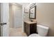 Nicely appointed bathroom featuring single vanity with granite countertop and decorative starfish artwork at 7604 49Th E Ave, Bradenton, FL 34203
