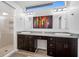 Modern bathroom featuring dual sinks, a vanity area, a walk-in shower, and a window providing natural light at 7604 49Th E Ave, Bradenton, FL 34203