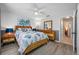 Cozy bedroom with wood furniture, ceiling fan, and stylish blue-themed decor at 7604 49Th E Ave, Bradenton, FL 34203