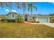 Charming single-story home with a well-manicured lawn and lush landscaping, creating curb appeal at 7604 49Th E Ave, Bradenton, FL 34203