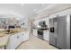 Bright kitchen featuring stainless steel appliances, granite counters, and access to the living area at 7604 49Th E Ave, Bradenton, FL 34203
