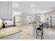 Bright kitchen with granite counters, an island with bar seating, and stainless steel appliances at 7604 49Th E Ave, Bradenton, FL 34203