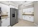 Kitchen with white cabinets, stainless steel refrigerator, granite counters, and tiled backsplash at 7604 49Th E Ave, Bradenton, FL 34203