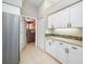 Convenient kitchen area featuring ample cabinetry and stainless steel refrigerator near the laundry room at 7604 49Th E Ave, Bradenton, FL 34203