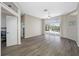 Bright living room with wood floors, ceiling fan, and sliding glass doors to the pool area at 7604 49Th E Ave, Bradenton, FL 34203
