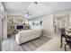 Open-concept living room featuring wood floors, a ceiling fan, and a sliding glass door at 7604 49Th E Ave, Bradenton, FL 34203