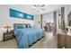 Main bedroom featuring sliding glass door, backyard view, ceiling fan, and hardwood floors at 7604 49Th E Ave, Bradenton, FL 34203