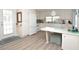 Bright kitchen with white appliances, modern flooring, and cozy dining area at 789 N Green Cir, Venice, FL 34285