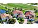 Stunning aerial view of the home situated on a golf course with lush landscaping and mature trees at 8025 Via Fiore, Sarasota, FL 34238
