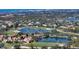 Expansive aerial shot of houses within golf course community, showcasing lakes and lush landscape at 8025 Via Fiore, Sarasota, FL 34238