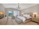 Tranquil bedroom with hardwood floors, complemented by neutral tones and natural light at 8025 Via Fiore, Sarasota, FL 34238