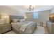 Neutral bedroom featuring a large bed, bedside tables, and a cozy rug on the hardwood floors at 8025 Via Fiore, Sarasota, FL 34238
