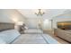 Comfortable bedroom with hardwood floors, chandelier, and large windows at 8025 Via Fiore, Sarasota, FL 34238