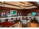 Beautifully designed bar with modern lighting, marble counters, and plentiful seating at 8025 Via Fiore, Sarasota, FL 34238