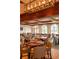 Well-lit dining room with multiple tables and views of the outdoors at 8025 Via Fiore, Sarasota, FL 34238