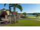 Attractive exterior view with a lush lawn, water views, and colorful landscaping at 8025 Via Fiore, Sarasota, FL 34238