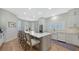 Bright kitchen with custom cabinets, stainless steel appliances, and a large center island with seating at 8025 Via Fiore, Sarasota, FL 34238