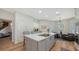 A gourmet kitchen with a large center island featuring a cooktop and seating at 8025 Via Fiore, Sarasota, FL 34238