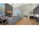 Inviting living room featuring hardwood floors, a fireplace, and an open floor plan at 8025 Via Fiore, Sarasota, FL 34238