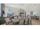 Spacious living and dining area featuring high ceilings, stylish furniture, and plenty of natural light at 8025 Via Fiore, Sarasota, FL 34238