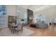 A bright, spacious living room featuring hardwood floors, tall ceilings, and plenty of natural light at 8025 Via Fiore, Sarasota, FL 34238