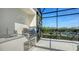 Outdoor kitchen with stainless steel grill and prep area, ideal for entertaining in the screened patio at 8025 Via Fiore, Sarasota, FL 34238
