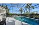 Screened-in pool area with lush landscaping providing privacy and shade at 8025 Via Fiore, Sarasota, FL 34238