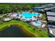 Aerial view of a large community pool, spa, cabanas and lush landscaping near clubhouse at 8262 Velda Trl, Sarasota, FL 34241