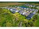 Aerial view of a residential community featuring modern homes, lush landscaping, and scenic waterways at 8262 Velda Trl, Sarasota, FL 34241